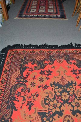 Lot 550 - A red ground rug with black brocade motifs and another