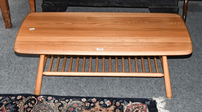 Lot 1273 - An Ercol elm coffee table with under tier,...