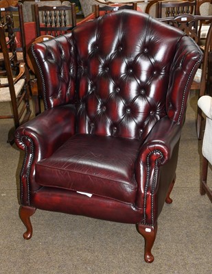 Lot 1319 - Ox blood leather Chesterfield wing back arm...