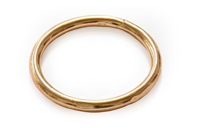 Lot 129 - A 9 carat gold bangle, inner measurement 5.6cm...