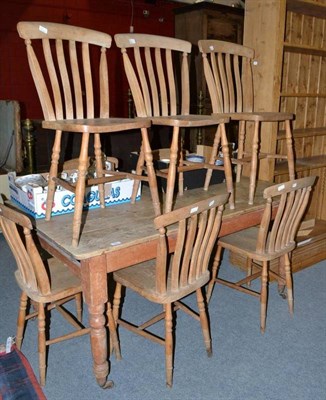 Lot 566 - Pine table and eight lath back chairs