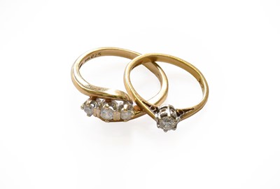 Lot 157 - A 9 carat gold diamond three stone twist ring,...