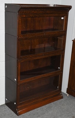 Lot 1104 - An oak Globe Wernicke style four tier bookcase,...