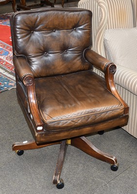 Lot 1321 - A reproduction leather office swivel armchair