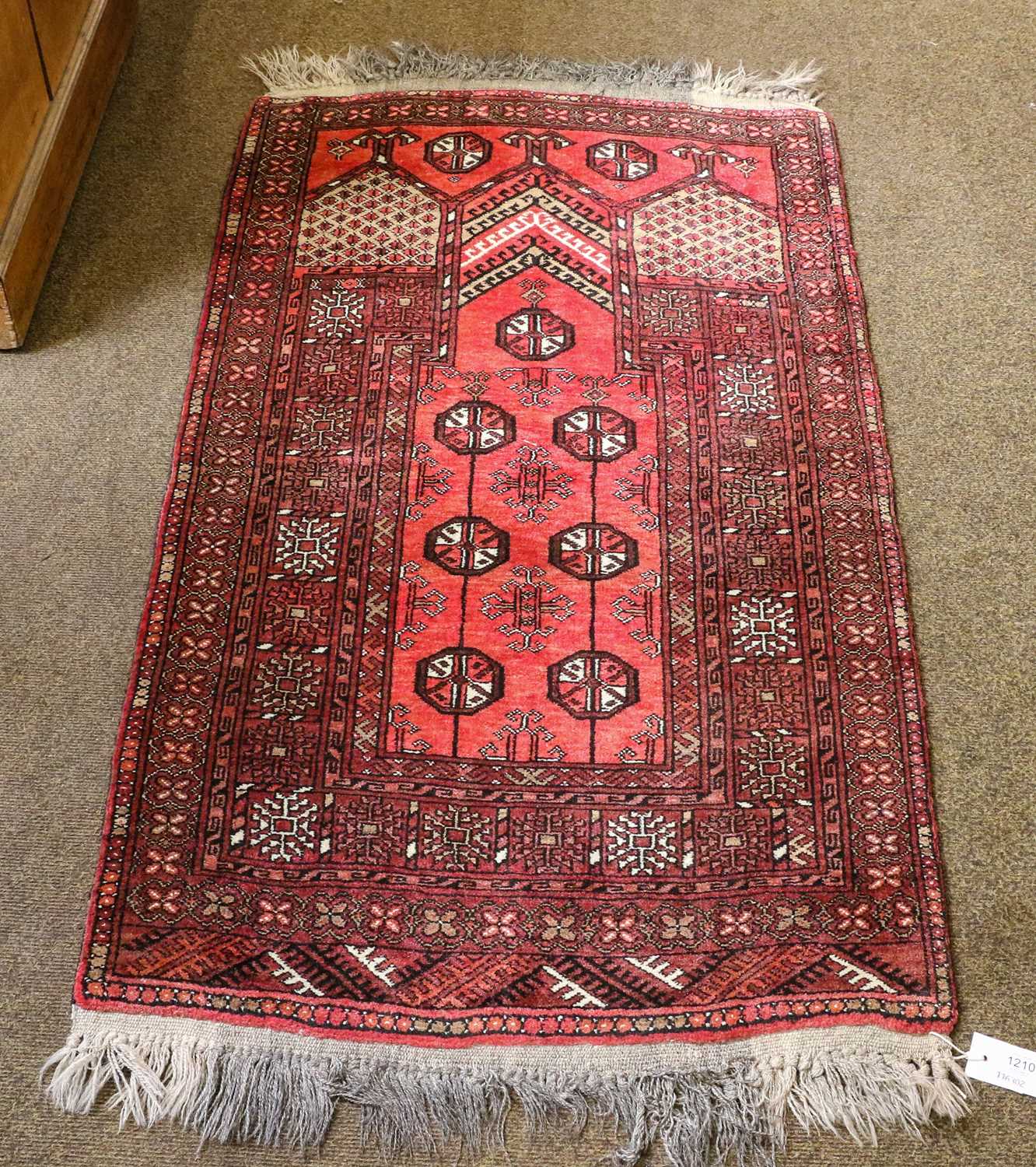 Lot 1087 - An Afghan Prayer Rug, the field of guls...