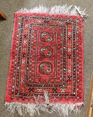 Lot 1087 - An Afghan Prayer Rug, the field of guls...