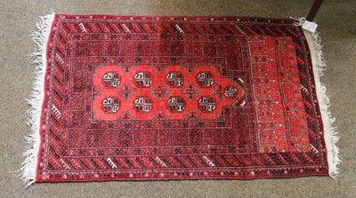 Lot 1211 - Afghan rug, the crimson field with four...