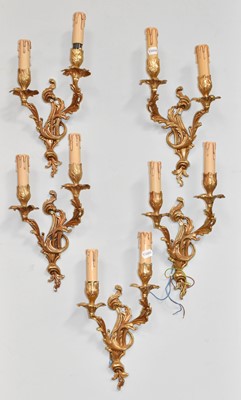 Lot 1180 - A set of five gilt metal rococo twin light...