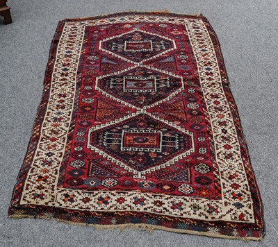 Lot 1226 - Yuruk rug, the aubergine field with three...