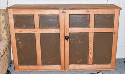 Lot 1250 - A pine two door cupboard fitted with fixed...