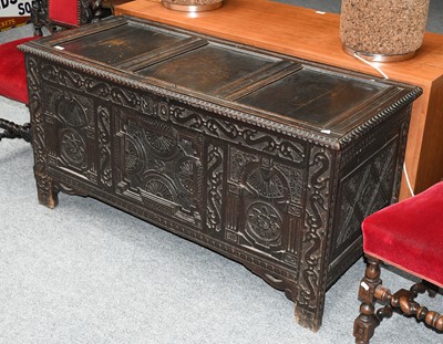 Lot 1270 - An 18th century carved oak three panel coffer...