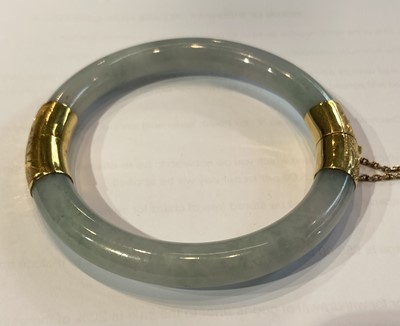 Lot 155 - A jade hinged bangle, two sections of jade...