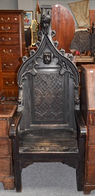 Lot 1142 - A Gothic revival carved oak throne chair