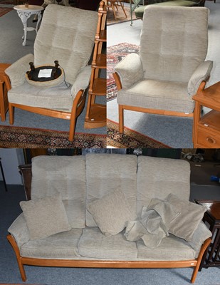 Lot 1246 - An Ercol light elm three piece suite (sofa and...