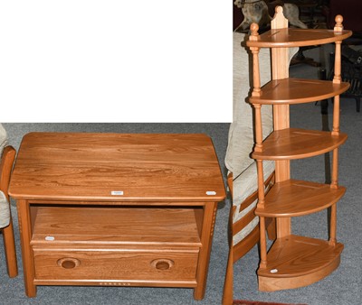 Lot 1247 - An Ercol light elm single drawer two-tier...