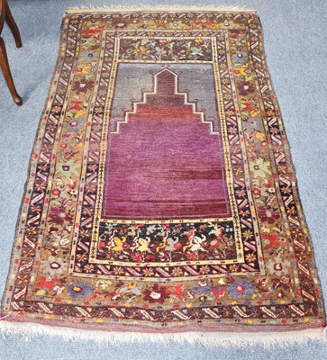 Lot 1188 - An Anatolian prayer rug, the stepped abrashed...