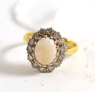 Lot 23 - An 18ct gold opal and diamond cluster ring