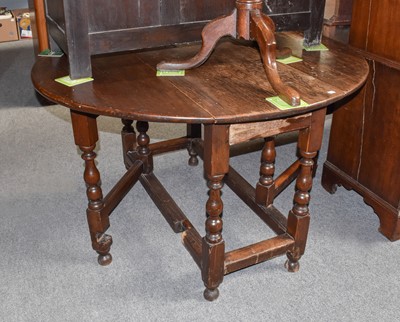 Lot 1120 - An 18th century oak gateleg dining table with...