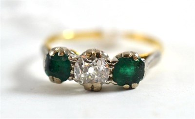 Lot 27 - A diamond and emerald three stone ring, estimated diamond weight 0.60 carat approximately
