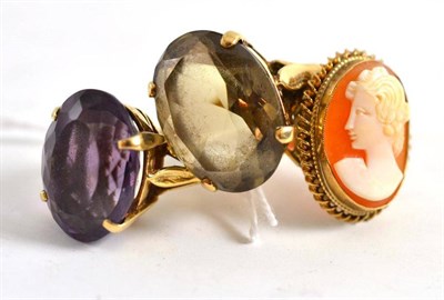Lot 29 - A 9ct gold smokey quartz ring, a 9ct gold amethyst ring and a 9ct gold cameo ring (3)