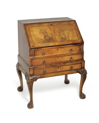 Lot 1242 - A Queen Anne Style Walnut and Featherbanded Bureau, the fall enclosing an attractive fitted...