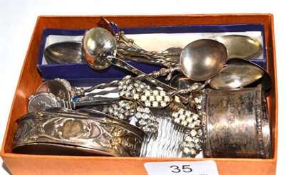 Lot 35 - A silver box decorated with winged cherubs, silver napkin ring, plated teaspoons, Viners napkin...