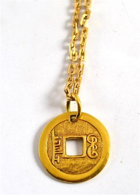 Lot 40 - A Chinese token on a 9ct gold fancy link bracelet