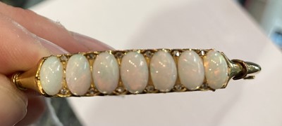 Lot 170 - An opal and diamond hinged bangle, stamped '9'...