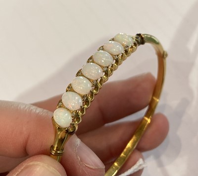 Lot 170 - An opal and diamond hinged bangle, stamped '9'...
