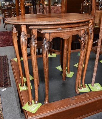 Lot 1124 - A nest of three mahogany tables with carved...