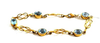 Lot 48 - A 9ct gold blue topaz set fancy link bracelet