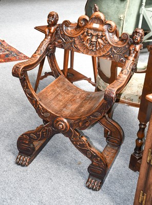 Lot 1294 - A continental carved walnut savonarola chair