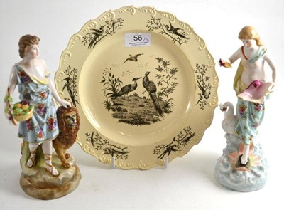 Lot 56 - A pair of Continental ceramic figures and an 18th century creamware plate