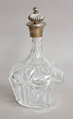 Lot 33 - A cut glass silver topped decanter by Barker...