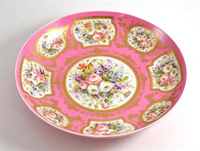 Lot 62 - Paris style porcelain large shallow dish with flower painted reserves and gilt decoration on a pink