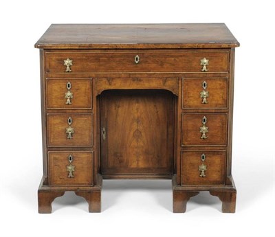 Lot 1246 - A George II Style Walnut and Featherbanded Kneehole Desk, early 20th century, the...