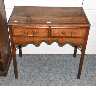 Lot 1265 - A George III oak lowboy, crossbanded in...