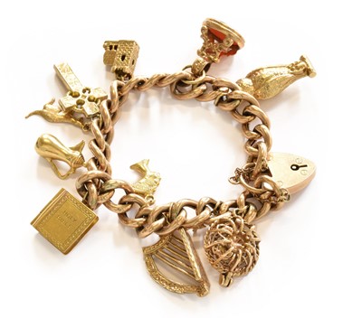 Lot 199 - A charm bracelet, stamped '9C', hung with ten...