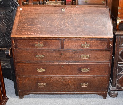 Lot 1141 - A Georgian oak bureau, 110cm by 58cm by 110cm...