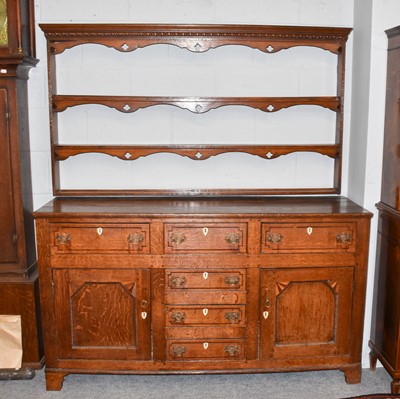 Lot 1179 - A George III oak dresser banded in rosewood...