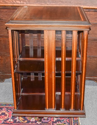 Lot 1078 - A mahogany revolving bookcase crossbanded in...