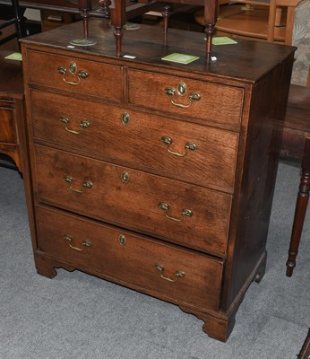 Lot 1159 - A George III oak chest of two short over three...