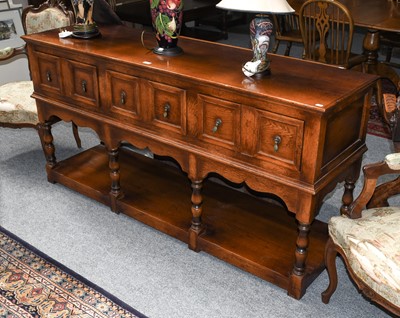 Lot 1291 - A Batheaston oak dresser base with three deep...