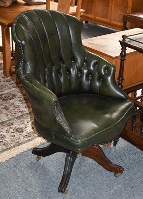 Lot 1280 - A button back green leather swivel office chair