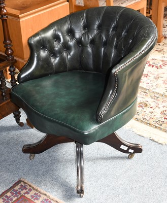 Lot 1281 - A button back green leather swivel office chair