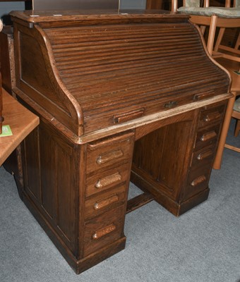 Lot 1167 - A 1920's oak roll top desk, 117cm by 67cm by...