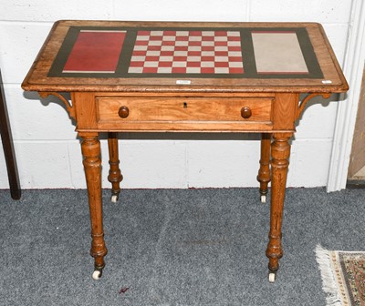 Lot 1266 - A Victorian light oak games table with leather...