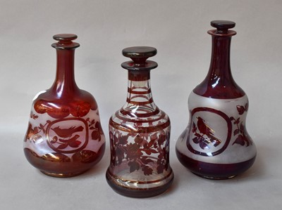 Lot 146 - Three Ruby Flashed Decanters and Stoppers,...