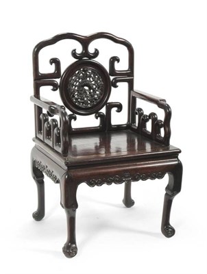 Lot 1262 - A Chinese Hardwood Open Armchair, 20th century, the circular splat carved with dogs of fo and...