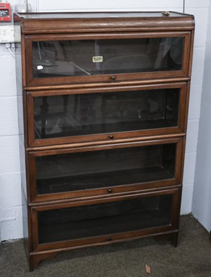 Lot 1186 - A Mahogany Four-tier Sectional Bookcase, by...